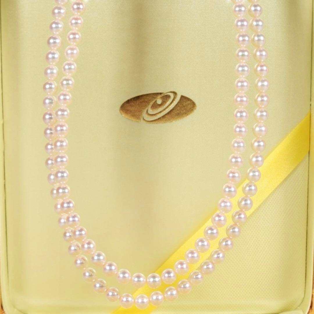 Akoya genuine pearl long necklace featuring two rows of flower pearl inclusions on a white background