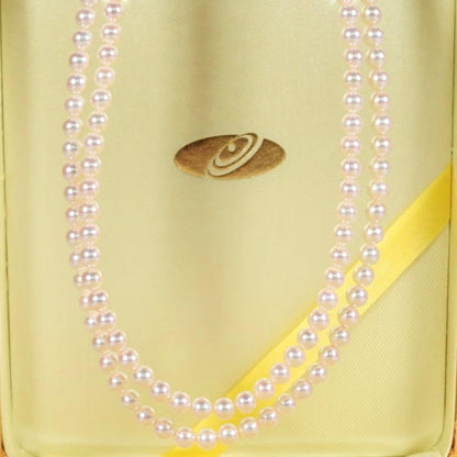 Akoya genuine pearl long necklace featuring two rows of flower pearl inclusions on a white background