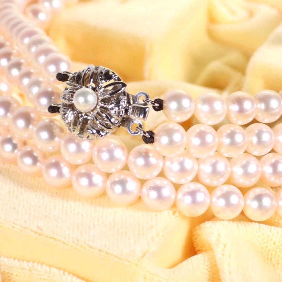 Akoya genuine pearl long necklace featuring two rows of flower pearl inclusions on a white background