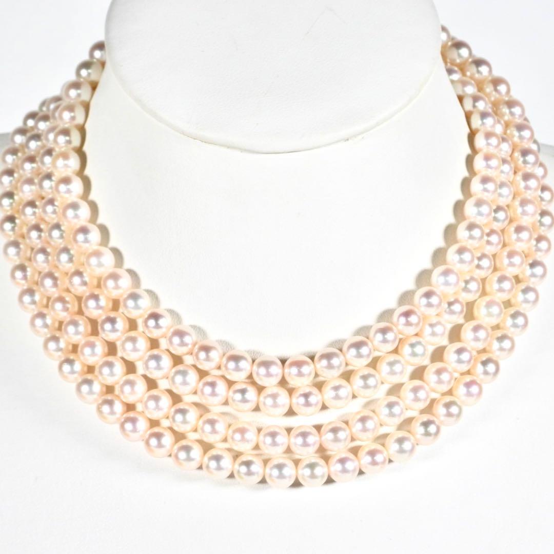 Akoya genuine pearl long necklace featuring two rows of flower pearl inclusions on a white background