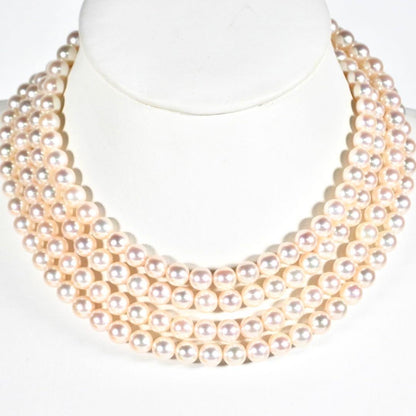 Akoya genuine pearl long necklace featuring two rows of flower pearl inclusions on a white background