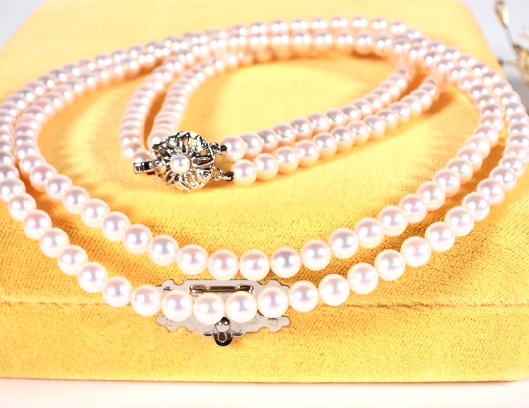 Akoya genuine pearl long necklace featuring two rows of flower pearl inclusions on a white background