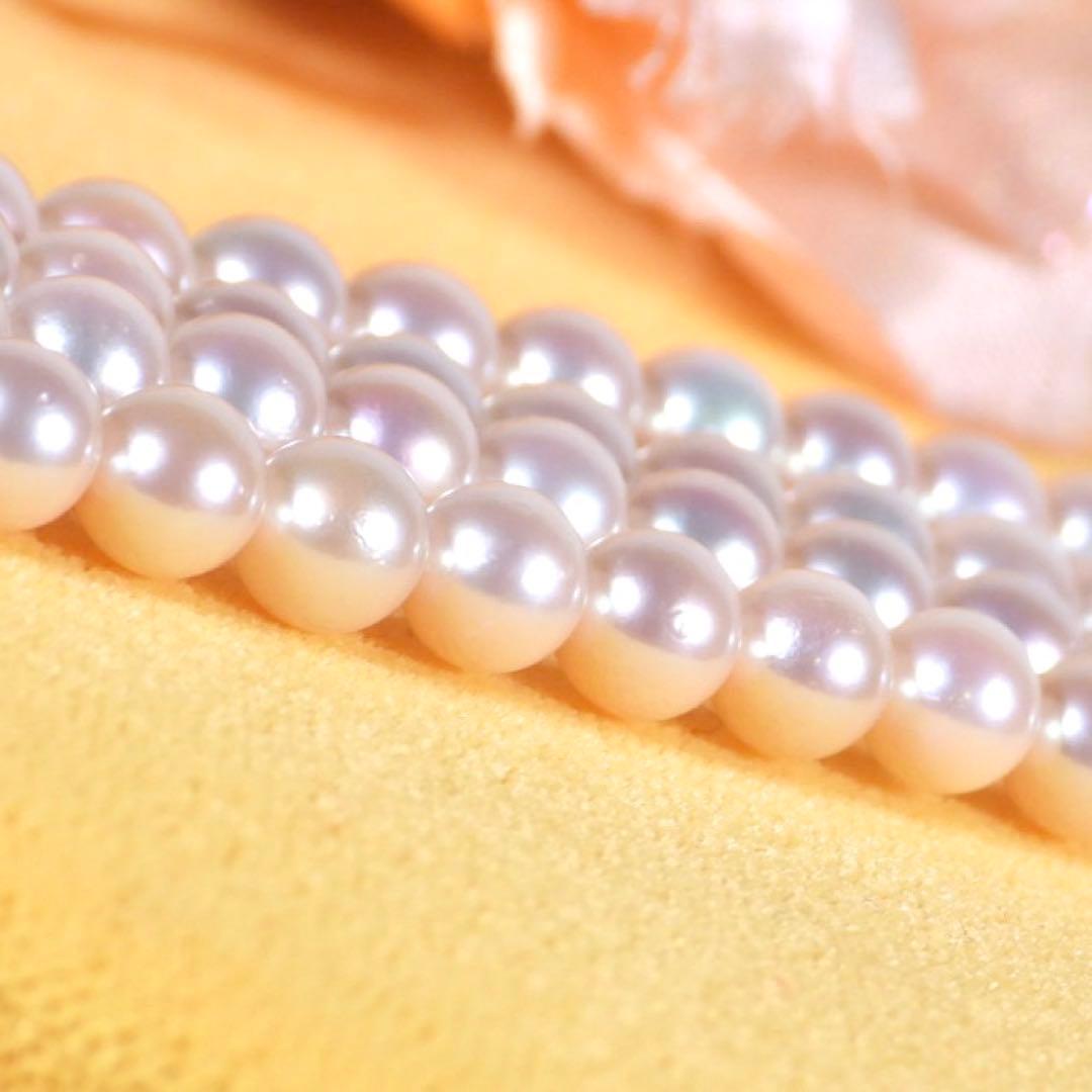 Akoya genuine pearl long necklace featuring two rows of flower pearl inclusions on a white background