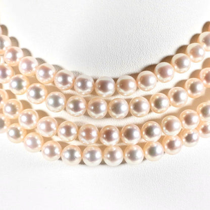 Akoya genuine pearl long necklace featuring two rows of flower pearl inclusions on a white background