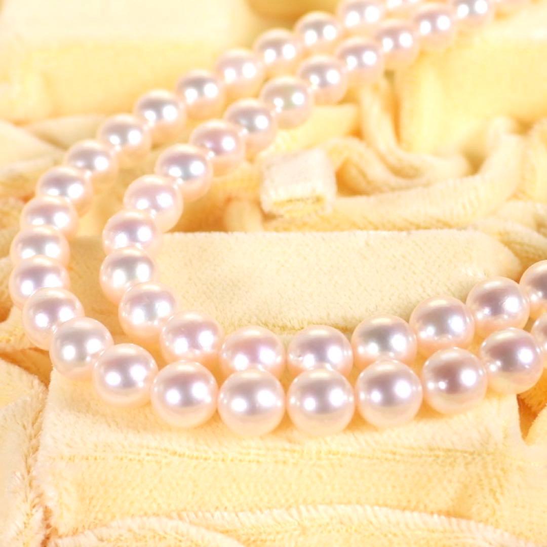 Akoya genuine pearl long necklace featuring two rows of flower pearl inclusions on a white background