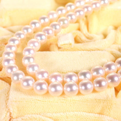 Akoya genuine pearl long necklace featuring two rows of flower pearl inclusions on a white background