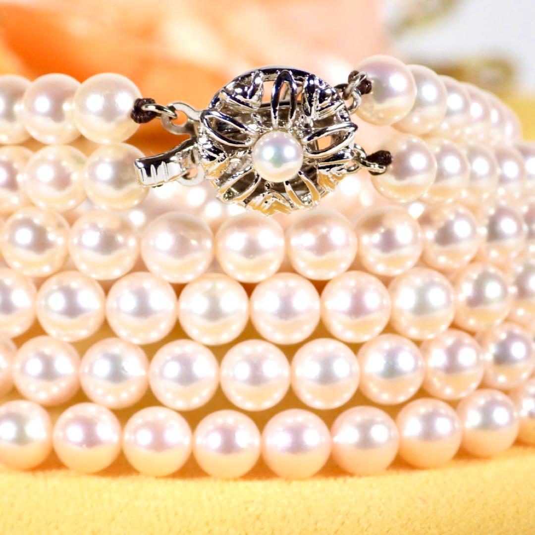 Akoya genuine pearl long necklace featuring two rows of flower pearl inclusions on a white background