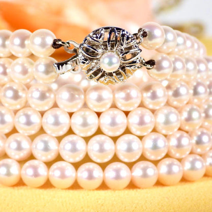 Akoya genuine pearl long necklace featuring two rows of flower pearl inclusions on a white background