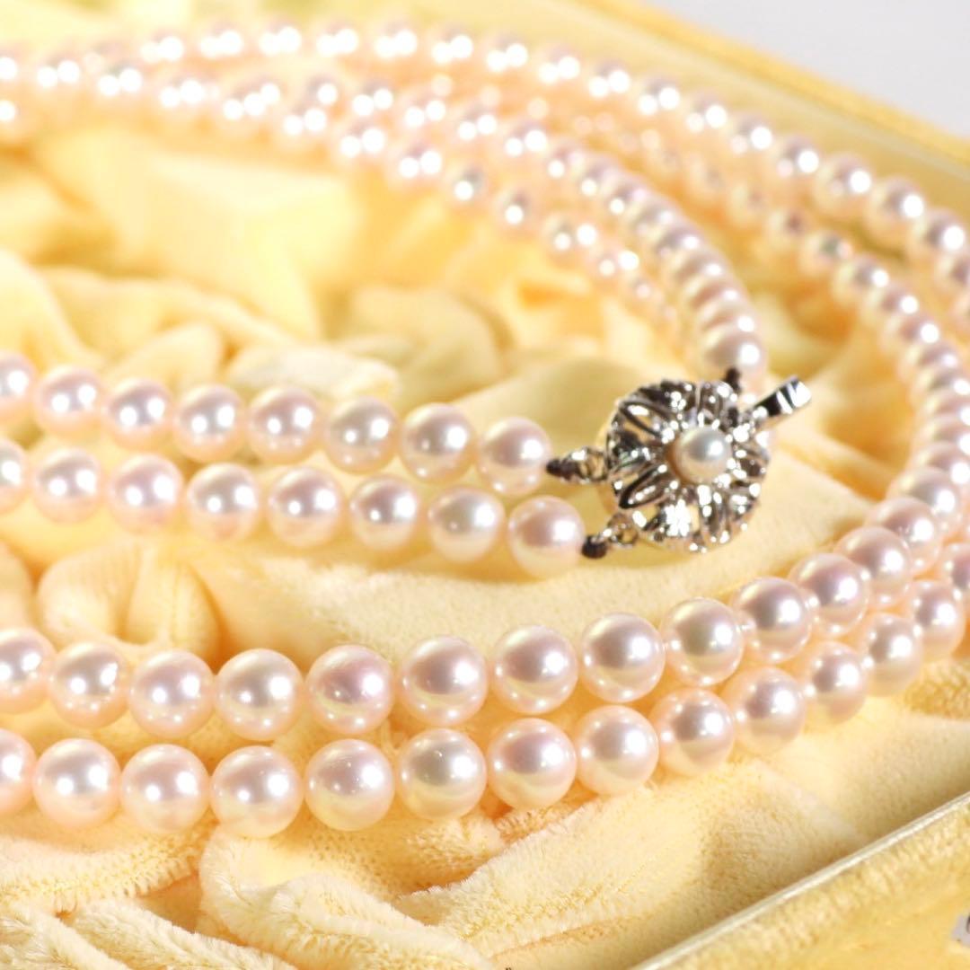 Akoya genuine pearl long necklace featuring two rows of flower pearl inclusions on a white background