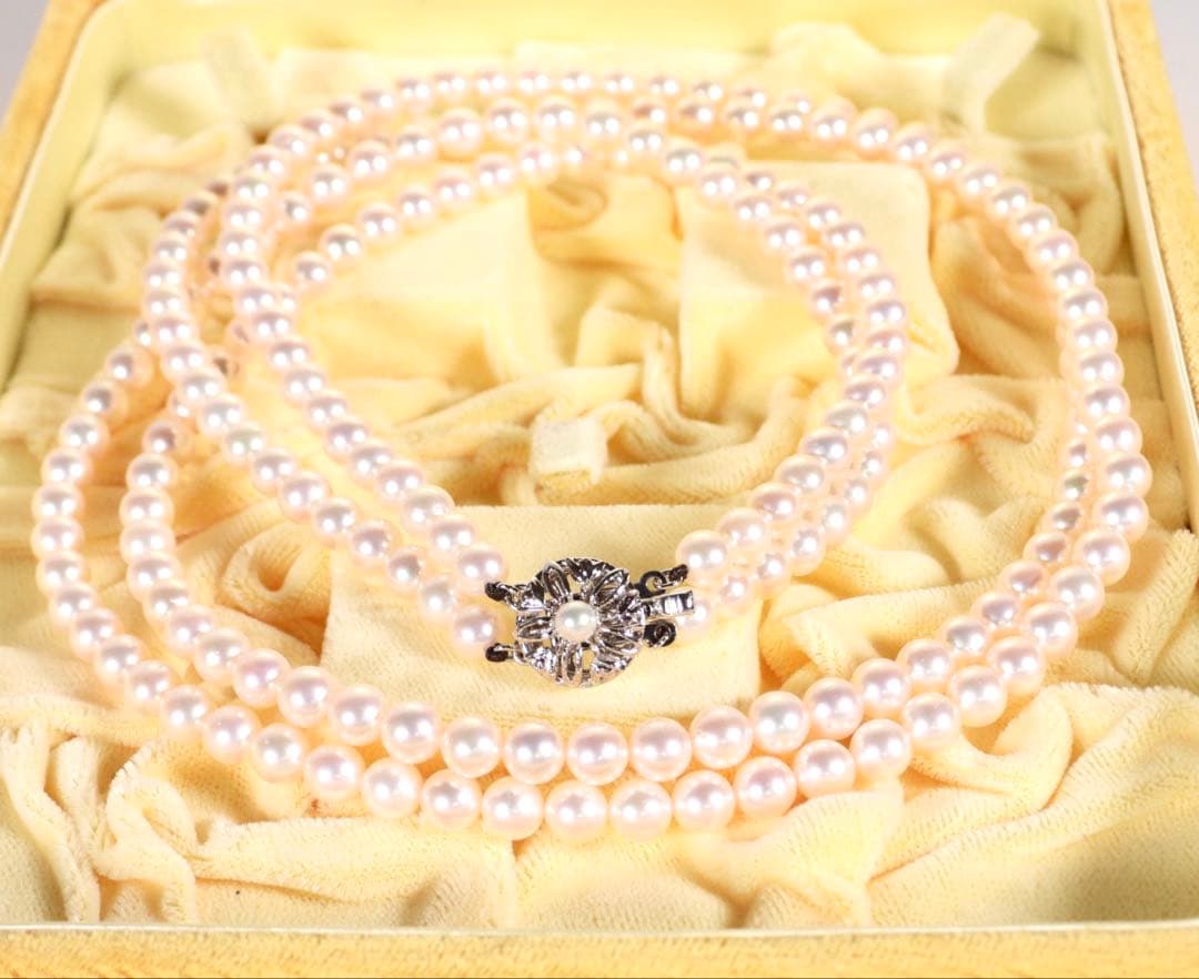 Akoya genuine pearl long necklace featuring two rows of flower pearl inclusions on a white background