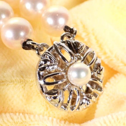 Akoya genuine pearl long necklace featuring two rows of flower pearl inclusions on a white background