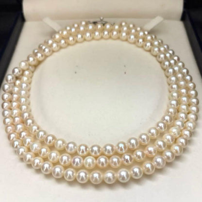 Long Akoya pearl necklace, 108cm length, 7mm pearls, 2-strand design, white pearls on a jewelry display