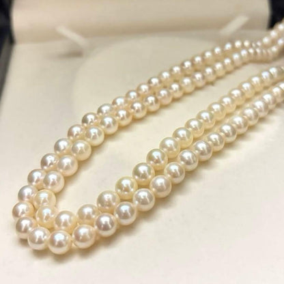 Long Akoya pearl necklace, 108cm length, 7mm pearls, 2-strand design, white pearls on a jewelry display