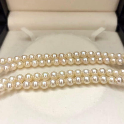 Long Akoya pearl necklace, 108cm length, 7mm pearls, 2-strand design, white pearls on a jewelry display