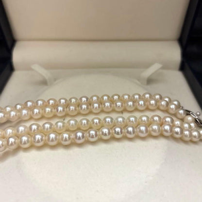 Long Akoya pearl necklace, 108cm length, 7mm pearls, 2-strand design, white pearls on a jewelry display