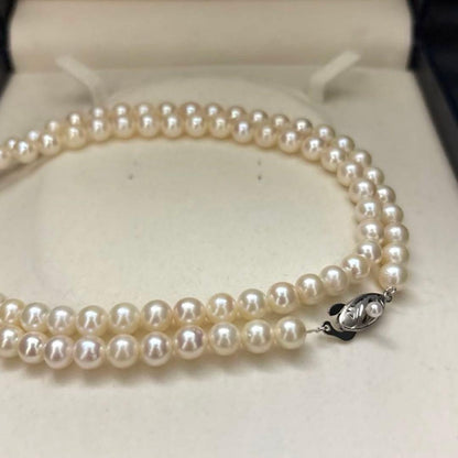 Long Akoya pearl necklace, 108cm length, 7mm pearls, 2-strand design, white pearls on a jewelry display