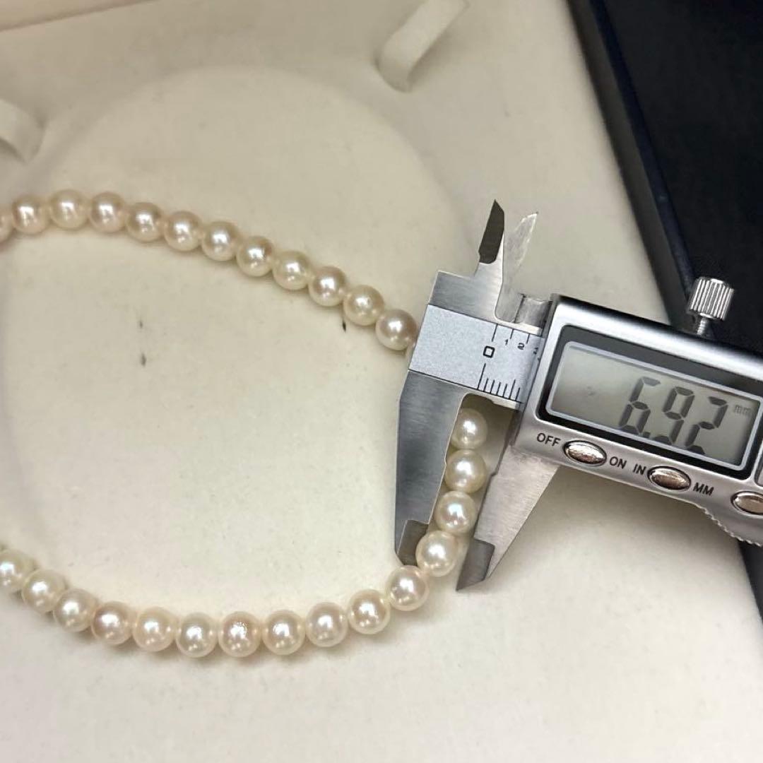 Long Akoya pearl necklace, 108cm length, 7mm pearls, 2-strand design, white pearls on a jewelry display