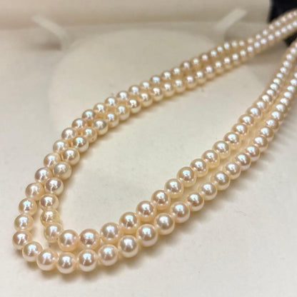 Long 107cm triple-strand Akoya pearl necklace with 6mm white pearls weighing 51 grams