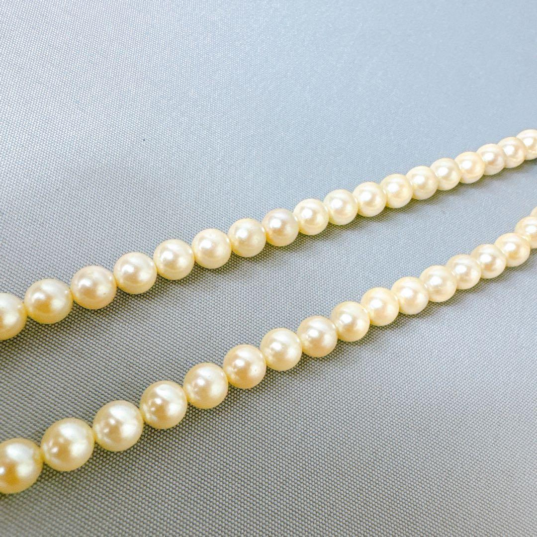 Honestone Akoya pearl necklace with 7mm white beads and silver parts on a white background