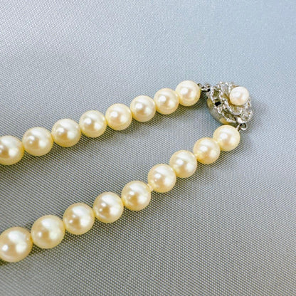 Honestone Akoya pearl necklace with 7mm white beads and silver parts on a white background