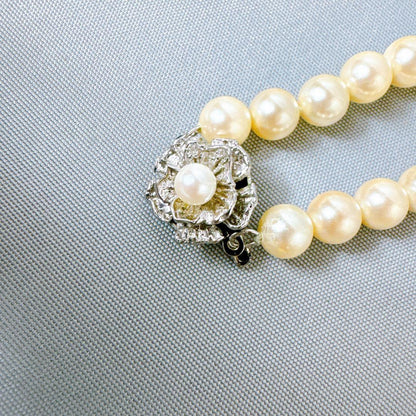 Honestone Akoya pearl necklace with 7mm white beads and silver parts on a white background