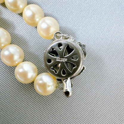 Honestone Akoya pearl necklace with 7mm white beads and silver parts on a white background