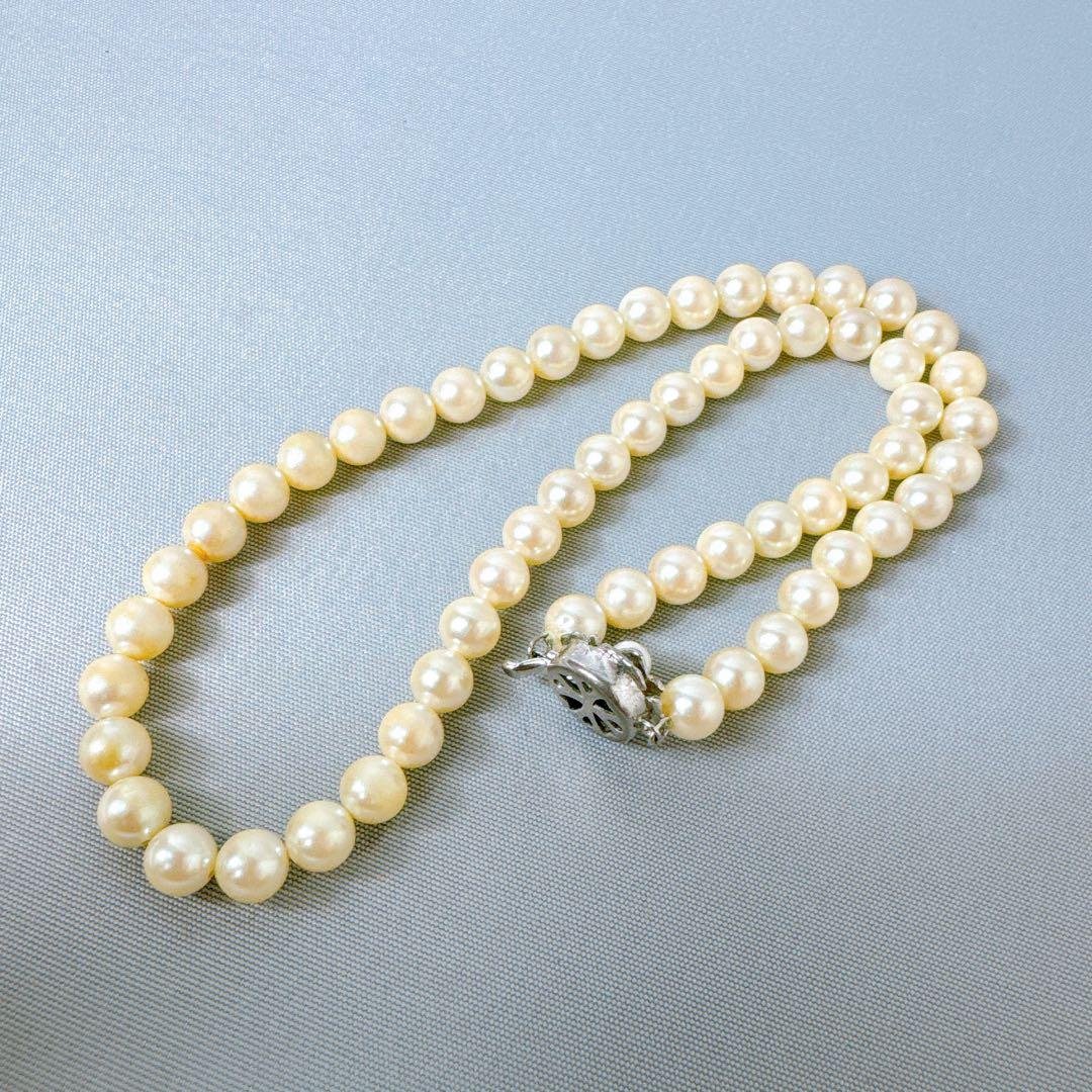 Honestone Akoya pearl necklace with 7mm white beads and silver parts on a white background