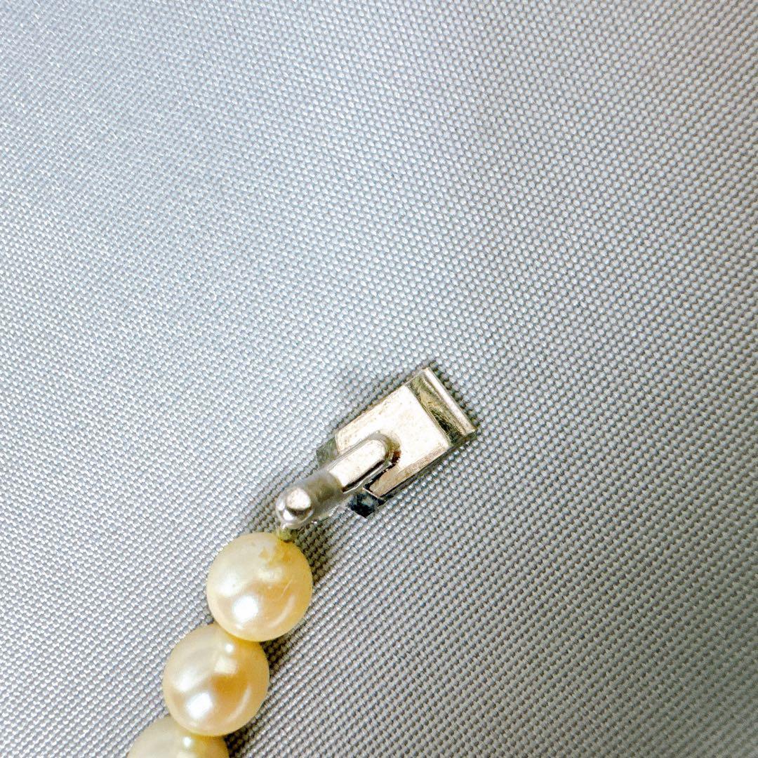Honestone Akoya pearl necklace with 7mm white beads and silver parts on a white background