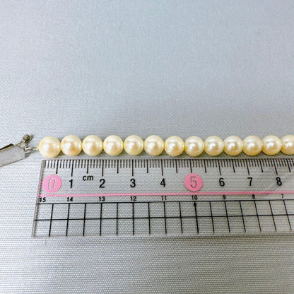 Honestone Akoya pearl necklace with 7mm white beads and silver parts on a white background