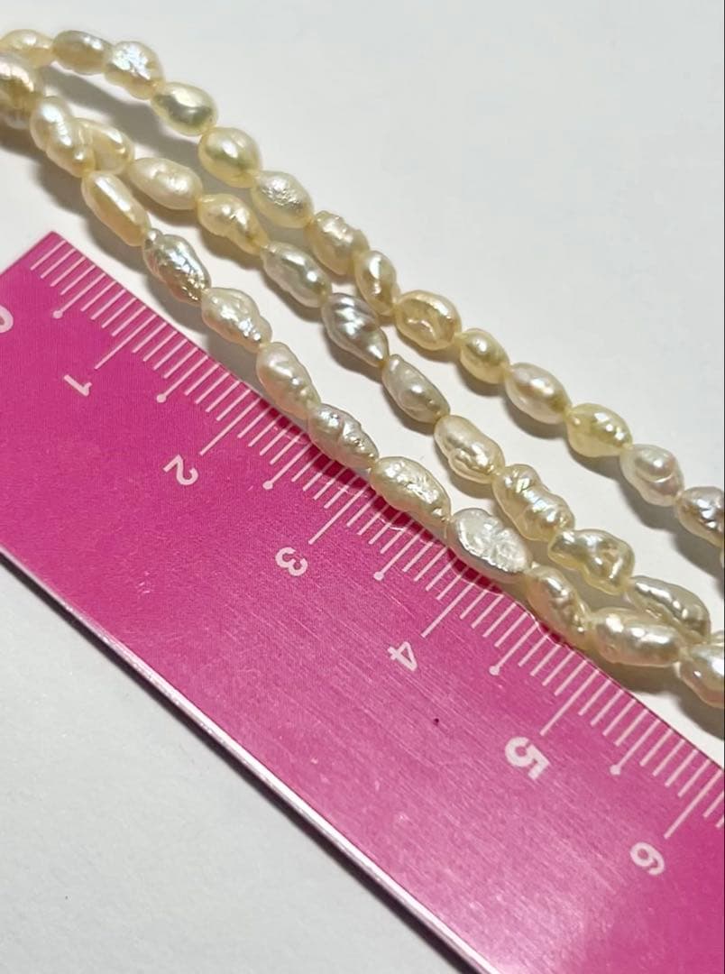 Tasaki genuine pearl necklace 66 cm length elegant round pearls on white background