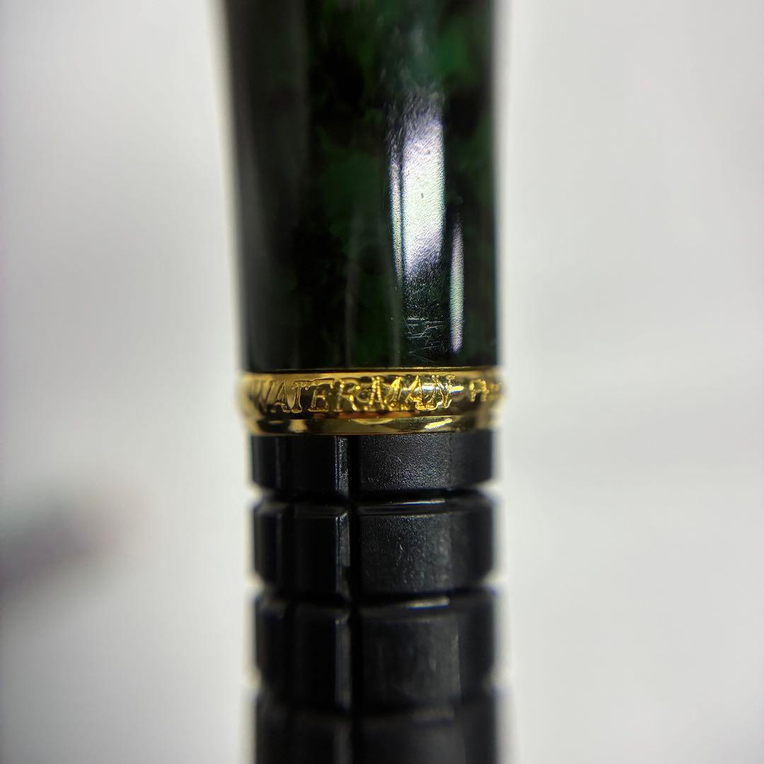 Waterman Exclusive Ballpoint Pen with green marble body, gold trim, and black textured grip