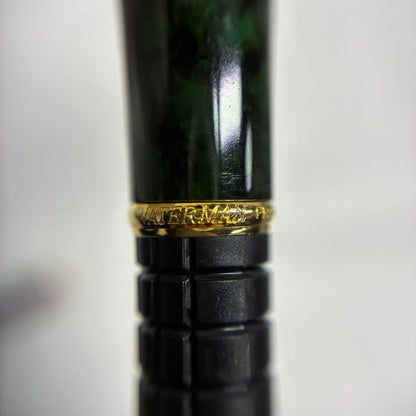Waterman Exclusive Ballpoint Pen with green marble body, gold trim, and black textured grip
