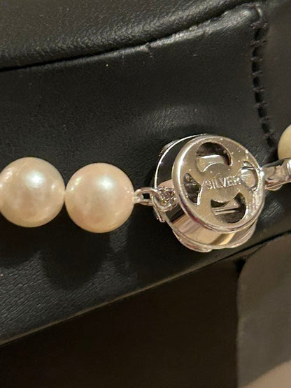 Akoya Pearl measuring 8.0×8.5 mm with its certificate displayed