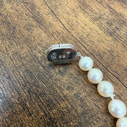 Tasaki pearl necklace and matching earrings displayed with the included case