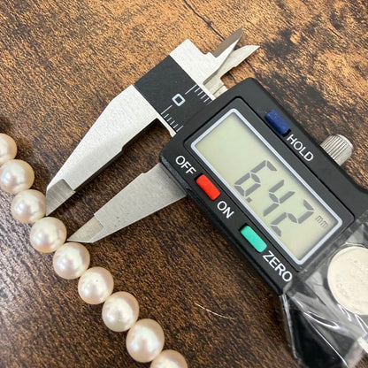 Tasaki pearl necklace and matching earrings displayed with the included case