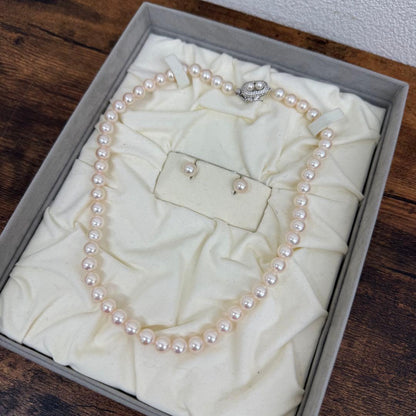 Tasaki pearl necklace and matching earrings displayed with the included case