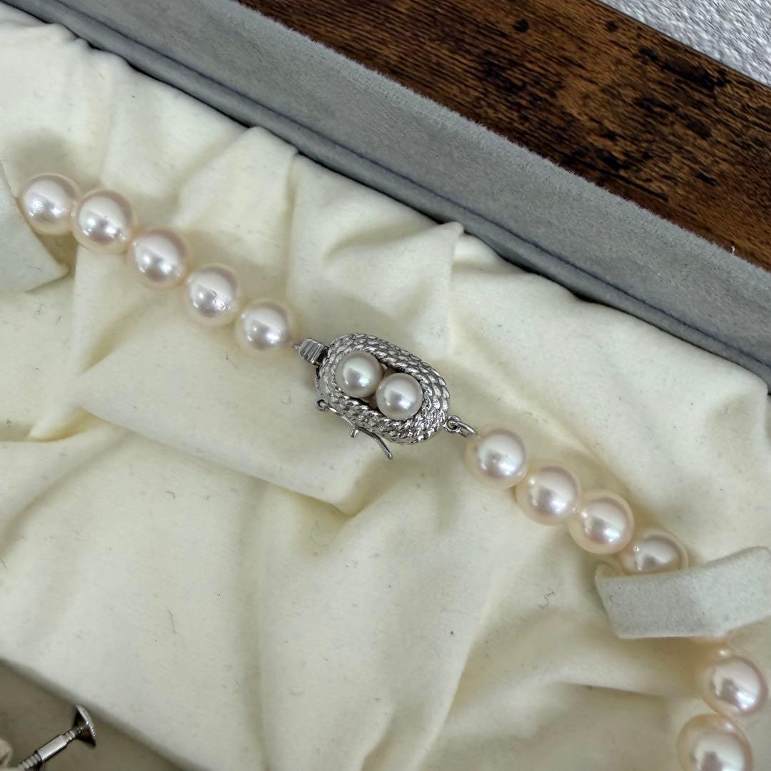 Tasaki pearl necklace and matching earrings displayed with the included case