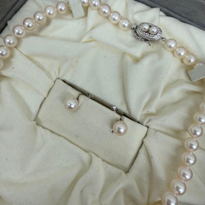 Tasaki pearl necklace and matching earrings displayed with the included case