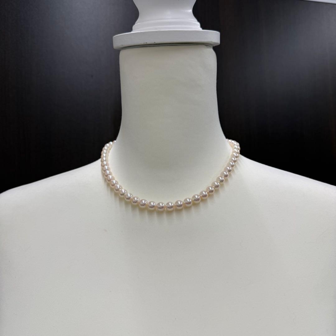 Tasaki pearl necklace and matching earrings displayed with the included case