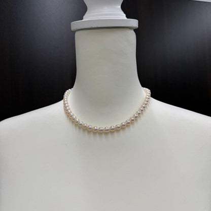 Tasaki pearl necklace and matching earrings displayed with the included case