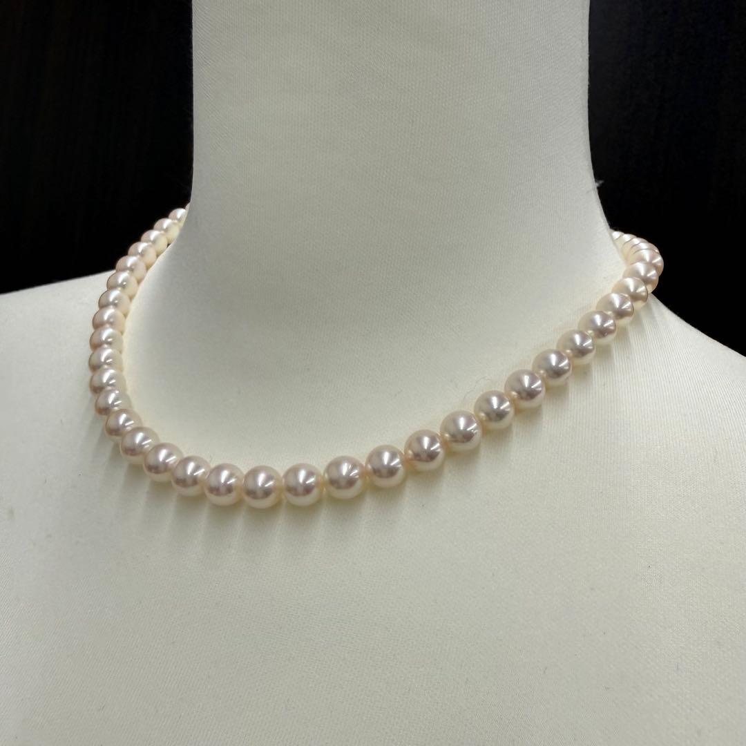 Tasaki pearl necklace and matching earrings displayed with the included case