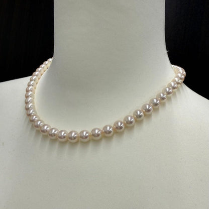 Tasaki pearl necklace and matching earrings displayed with the included case