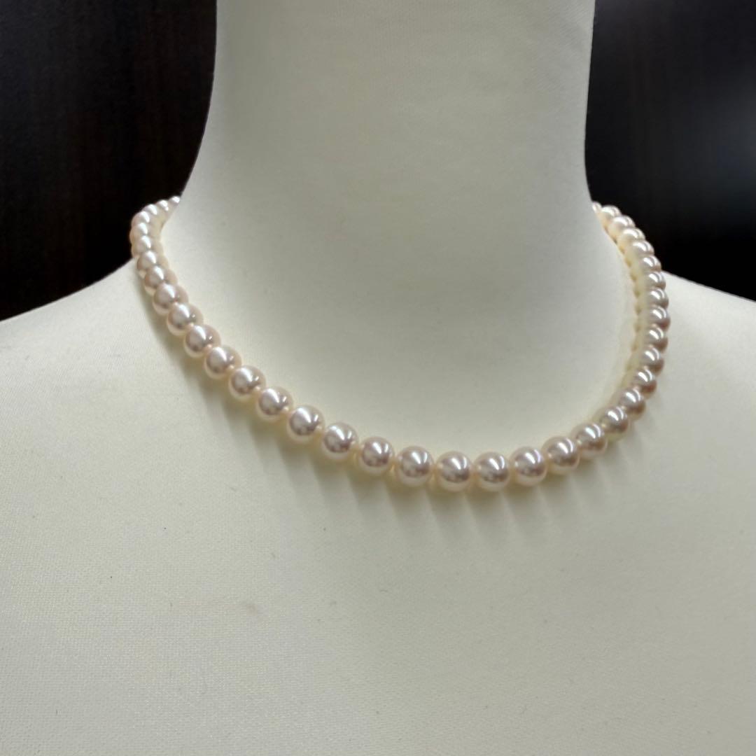 Tasaki pearl necklace and matching earrings displayed with the included case