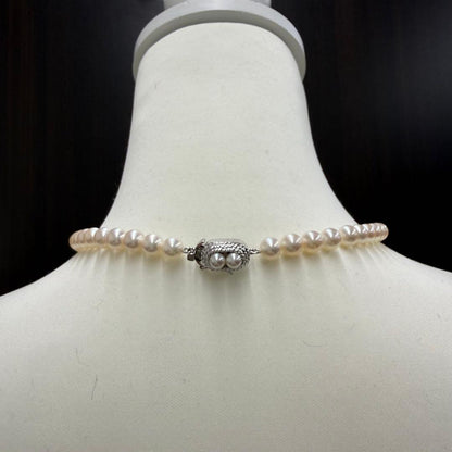Tasaki pearl necklace and matching earrings displayed with the included case