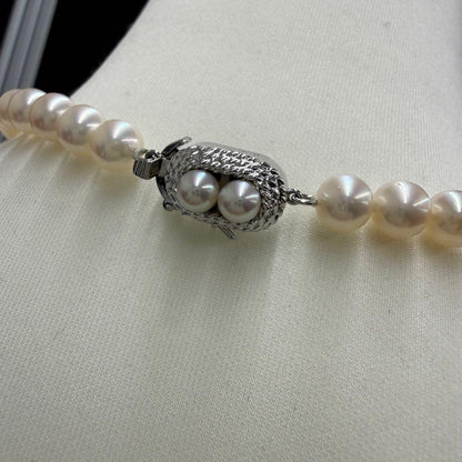 Tasaki pearl necklace and matching earrings displayed with the included case