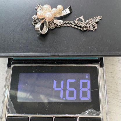 Mikimoto silver necklace featuring a ribbon design with 5 Akoya pearls ranging from 4.0mm to 5.6mm