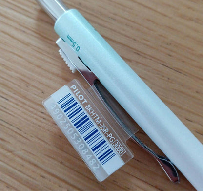 Pilot Melty 2+1 multi-function swing-type pen with black and red ballpoint tips and green 0.5mm mechanical pencil barrel