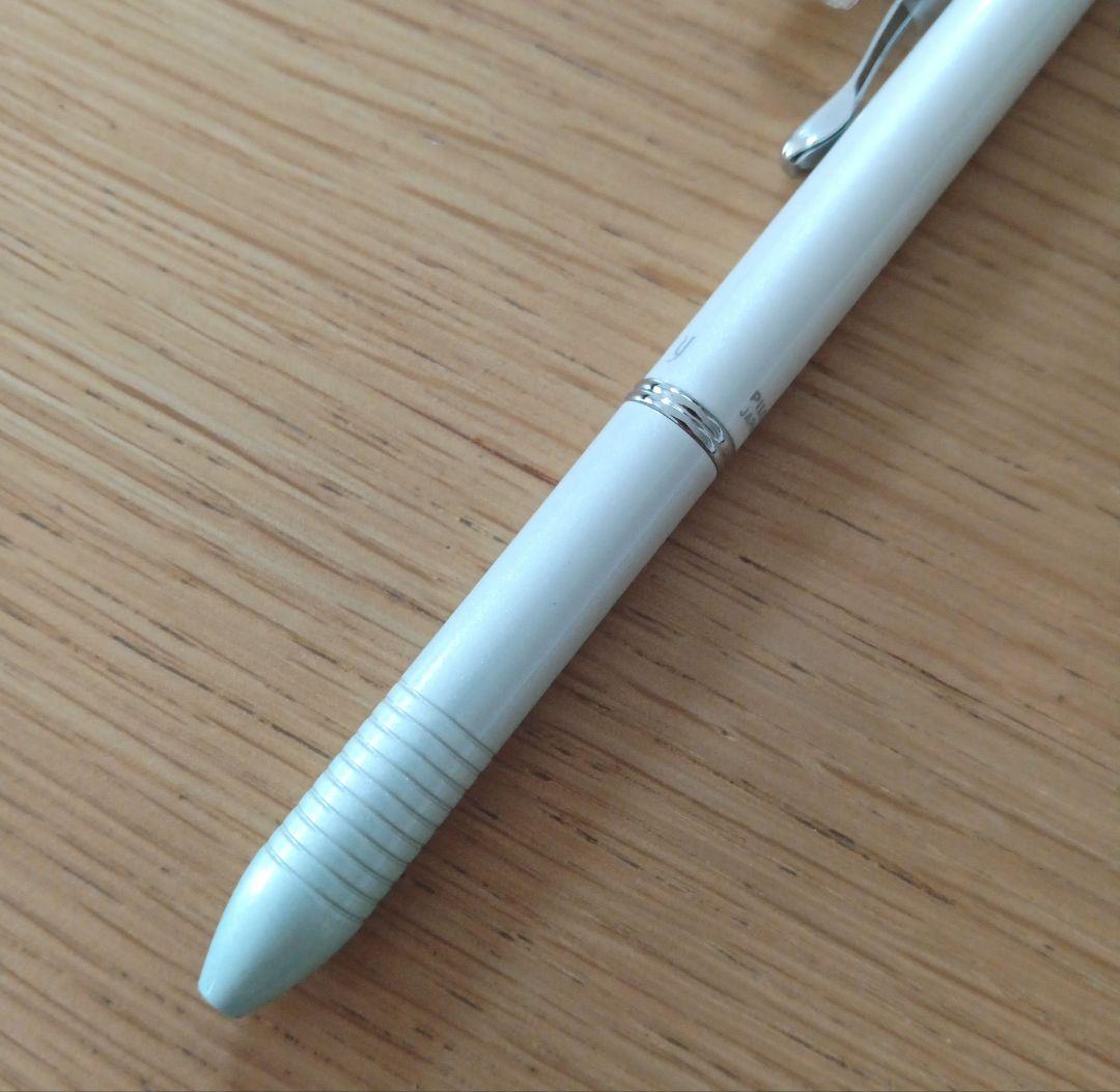 Pilot Melty 2+1 multi-function swing-type pen with black and red ballpoint tips and green 0.5mm mechanical pencil barrel