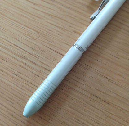Pilot Melty 2+1 multi-function swing-type pen with black and red ballpoint tips and green 0.5mm mechanical pencil barrel