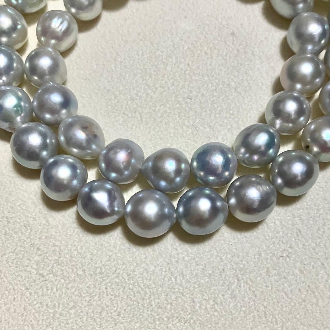 Akoya pearl necklace with 9.0mm pearls laid out showing clasp and identification book